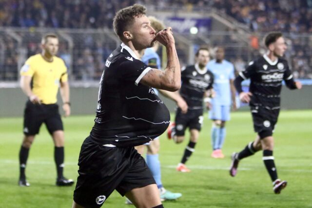 Joel Grodowski jubelt mit einem Ball unter seinem Trikot.