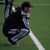 David Sawatzki, Trainer des BV Brambauer, kniet am Spielfeldrand.