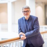 Oberbürgermeister Westphal lehnt an einem Geländer im Rathaus.