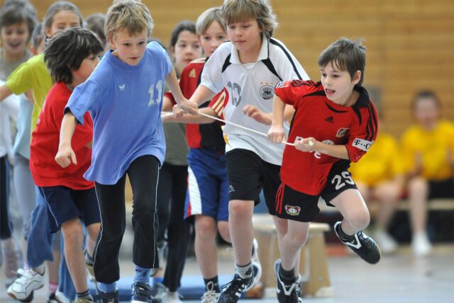 Schüler im Sportunterricht in einer Turnhalle.