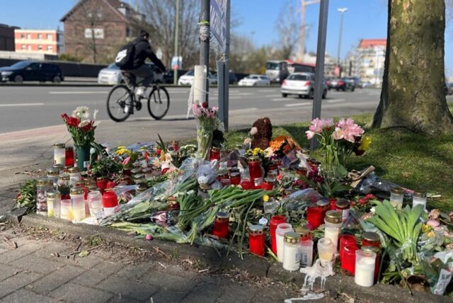 Blumen und Kerzen am Straßenrand