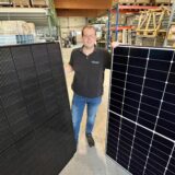 Elektrotechnikermeister Marvin Röttger mit zwei PV-Modulen.