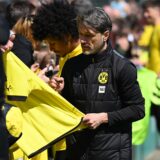Niko Kovac unterschreibt auf einem Trikot.