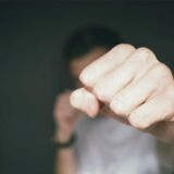 Ein Jugendlicher streckt die Faust in Richtung der Kamera.