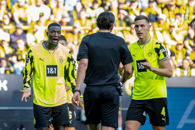 Nico Schlotterbeck und Serhou Guirassy im Gespräch mit dem Schiedsrichter.