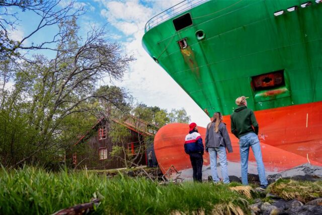 Ein Containerschiff ist in einem norwegischen Fjord kurz vor einem Haus am Wasser zum Stehen gekommen.