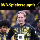 Julian Brandt stemmt die Hände in die Hüfte. Hinter ihm gehen Karim Adeyemi und Jamie Gittens über den Platz.