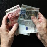 Ein älterer Mensch hat Geldscheine in der Hand.