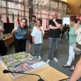 Interessierte Bürger und Anwohner stehen um ein Reißbrett von der Bergkamener Stadtmitte, in das Fähnchen mit Ideen gesteckt werden können.
