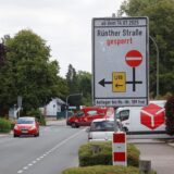 Straßenszene in Bergkamen mit Hinweisschild zur Sperrung der Rünther Straße ab dem 14.07.2025; Autos fahren auf offener Fahrbahn, Umleitung ist ausgeschildert.