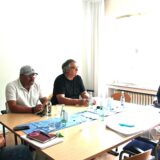 Vier Personen sitzen um einen Tisch.